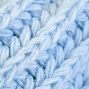 Örgü yün kumaşın ayrıntıları. Tekstil arka planı. Yünlü doku arka planı, örgü yün kumaş, tüylü yumuşacık tekstil. Yakın çekim.