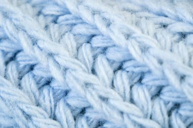 Örgü yün kumaşın ayrıntıları. Tekstil arka planı. Yünlü doku arka planı, örgü yün kumaş, tüylü yumuşacık tekstil. Yakın çekim.