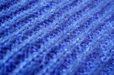Örgü yün kumaşın ayrıntıları. Tekstil arka planı. Yünlü doku arka planı, örgü yün kumaş, tüylü yumuşacık tekstil. Yakın çekim.