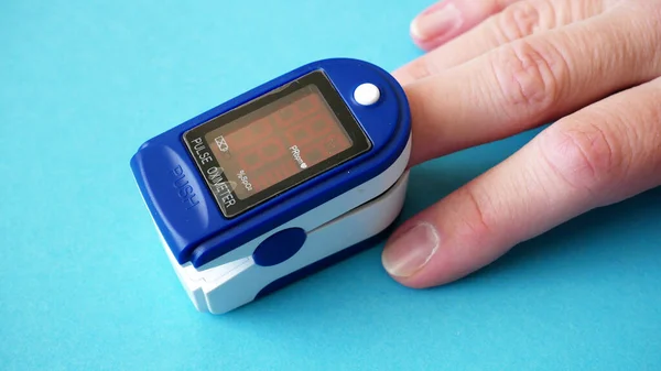 pulse oximeter for finger tip simultaneous monitoring of blood flow and transcutaneous oxygen on table, closeup