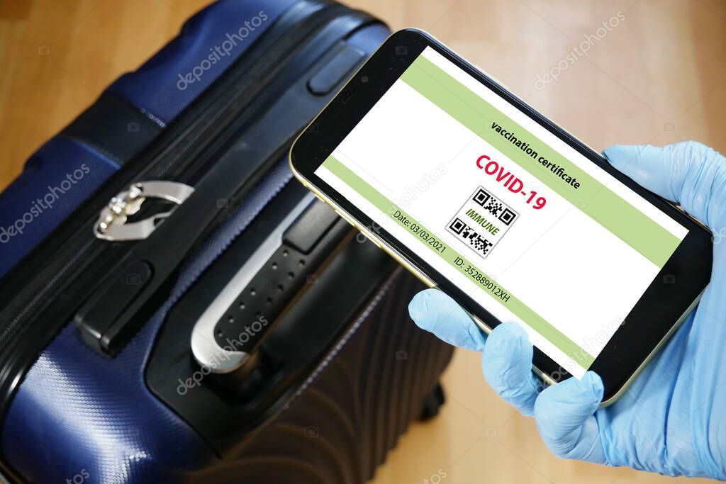 Vaccination passport on a mobile phone allowing travel in hand. Vaccination against the coronavirus Covid 19.Imunity or Health passport, closeup