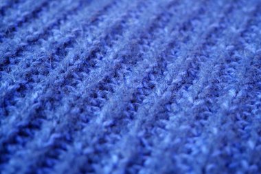 Örgü yün kumaşın ayrıntıları. Tekstil arka planı. Yünlü doku arka planı, örgü yün kumaş, tüylü yumuşacık tekstil. Yakın çekim.