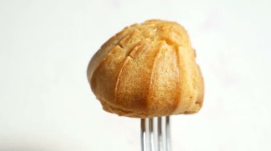 Kremalı pasta ya da beyaz arka planda çilekle doldurulmuş profiterol.