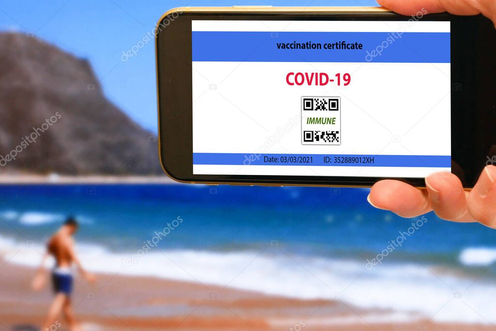 Vaccination passport on a mobile phone allowing travel in hand. Vaccination against the coronavirus Covid 19.Imunity or Health passport, closeup