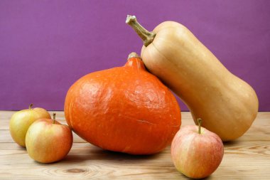 ahşap zemin üzerinde bir sürü portakal kabağı ve elma, yakın plan