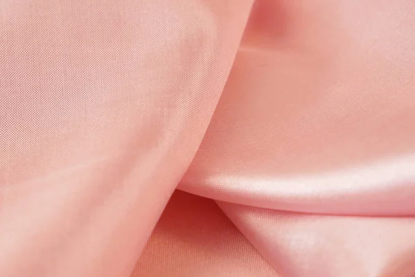 Light pink fabric texture, silk background, surface, closeup