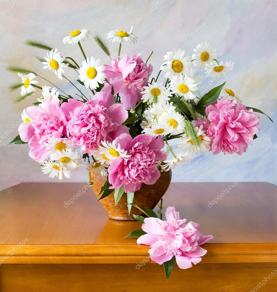 Still life with peonies and chamomiles on painting background Stock ...