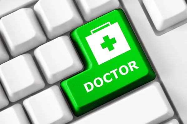 Botón de color en el teclado con la imagen de la maleta del médico y texto del médico. Concepto de salud —  Fotos de Stock