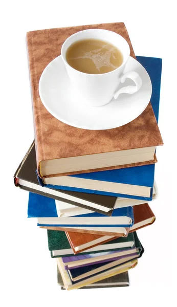 Stock image Coffee cup on the big stack of books isolated on white background