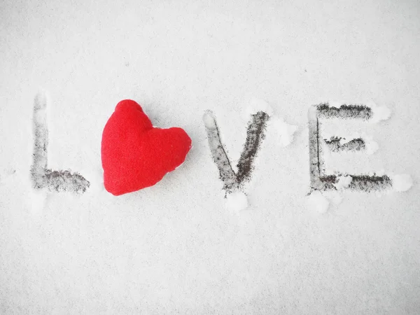Red heart on the snow and love word. Valentine's day concept. Love concept — Stock Photo, Image