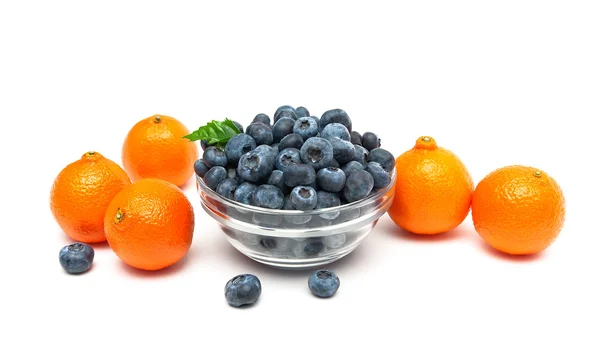 Tangerines and blueberries on a white background close-up. — Stock Photo, Image