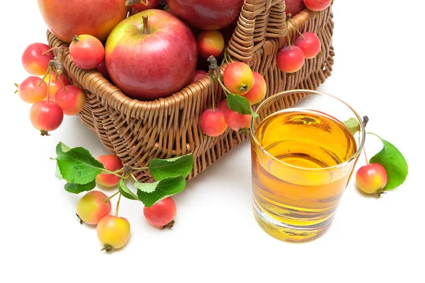 Apples in a basket and a glass of apple juice on a white backgro — Stock Photo, Image