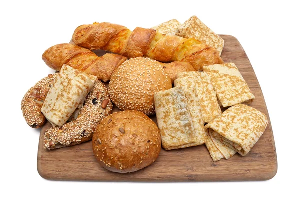 Pancakes and baked goods on a cutting board — Stock Photo, Image