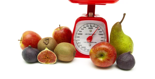 Fresh fruit and kitchen scale on white background — Stock Photo, Image