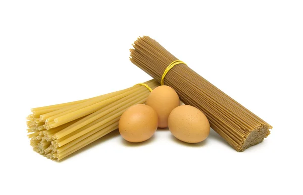 Different pasta and chicken eggs isolated on white background — Stock Photo, Image