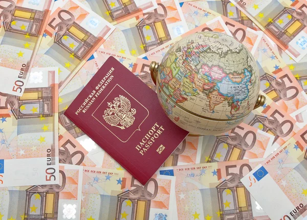 Globe and passport on a background of euros — Stock Photo, Image