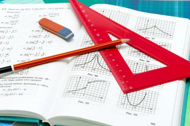school supplies and textbooks on mathematics close up clipart