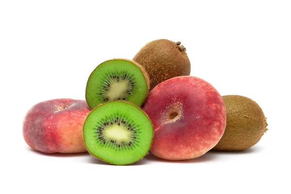 Kiwi and peaches close-up on a white background — Stock Photo, Image