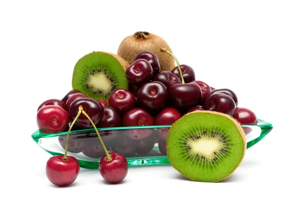 Ripe kiwi and cherry closeup on a white background — Zdjęcie stockowe