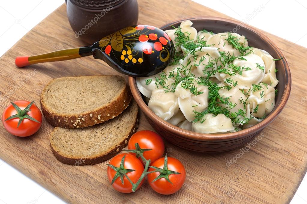 Russian cuisine: dumplings with sour cream and dill.
