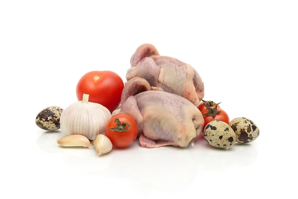 Quail carcasses, eggs and vegetables on a white background — Stock Photo, Image