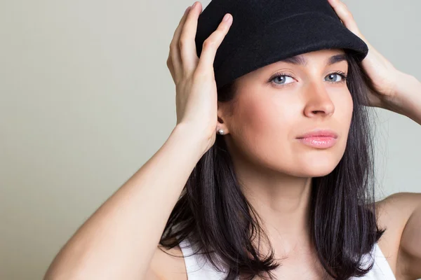 The attractive woman in a cap — Stock Photo, Image