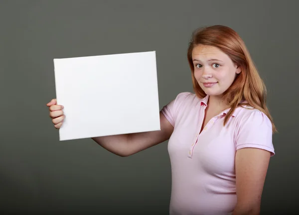 Young teenager in the studio with a blank sign — Stock Photo, Image