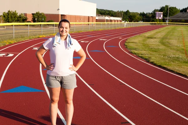 young woman exercising on a track outdoors