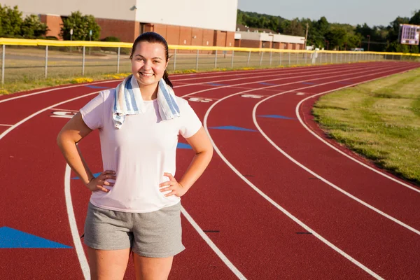 Young woman exercising on a track outdoors — Stock Photo, Image