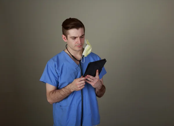 Young Doctor using a tablet — Stock Photo, Image