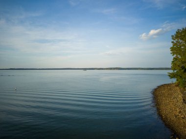 Aerial shot of a man-made reservoir in Kentucky on a partly cloudy day