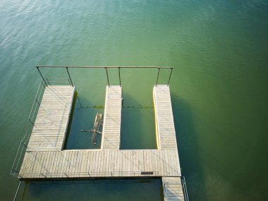 A view of a dock and a body of water. The dock is on the right side of the water