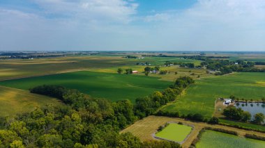 Drone shot of Midwest farmlands in mid-September on a partly cloudy day