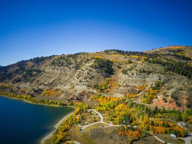 Drone shot of Slide Lake in Wyoming in autumn bright blue skies