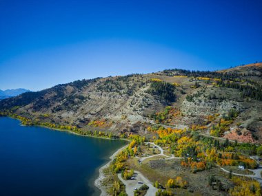 Drone shot of Slide Lake in Wyoming in autumn bright blue skies