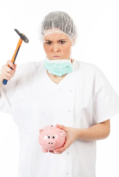 Vrouw arts einden piggy bank — Stockfoto