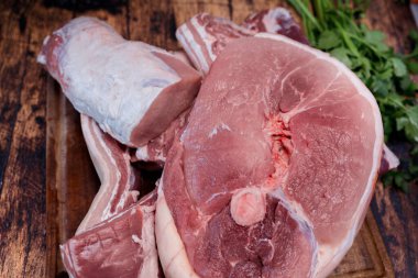 Tahta kesme tahtasında bir sürü taze domuz eti var.