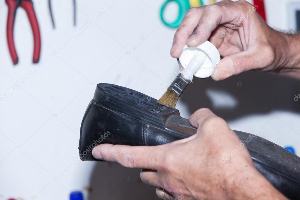 Shoemaker repairs a shoe
