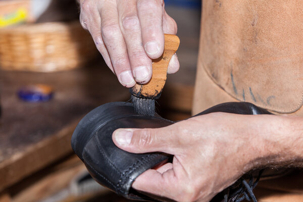 Shoemaker puts shoe polish