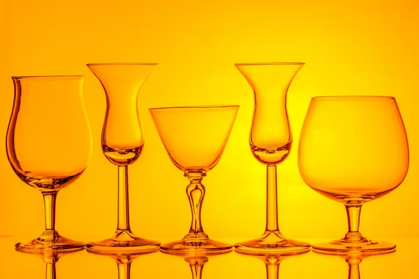 Silhouette of wine glasses on orange background — Stock Photo, Image