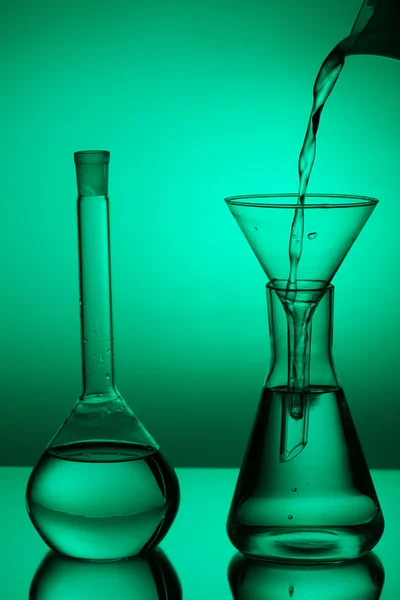 Laboratory glassware on color background Royalty Free Stock Photos