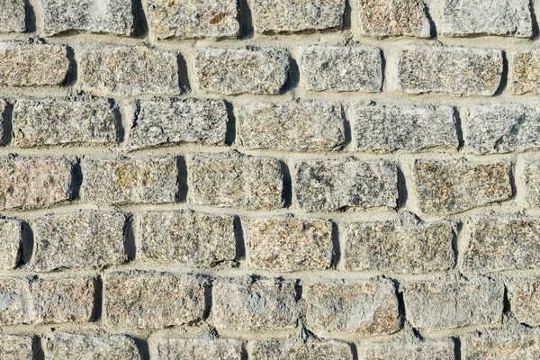 Parede de pedras. tijolos de granito como plano de fundo — Fotografia de Stock