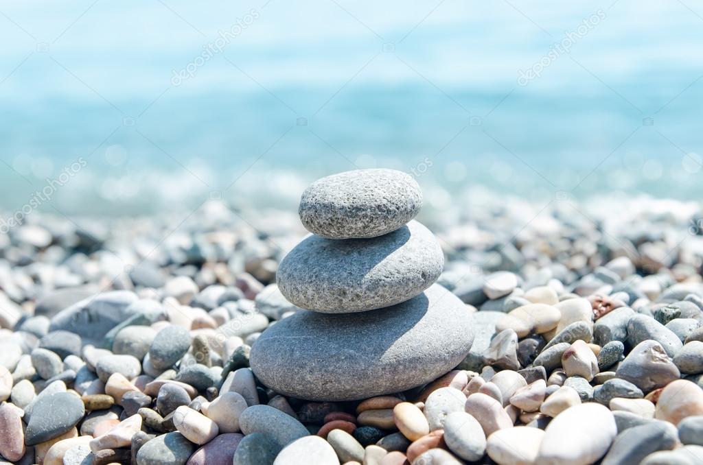 three stones on stack near sea. zen like concept