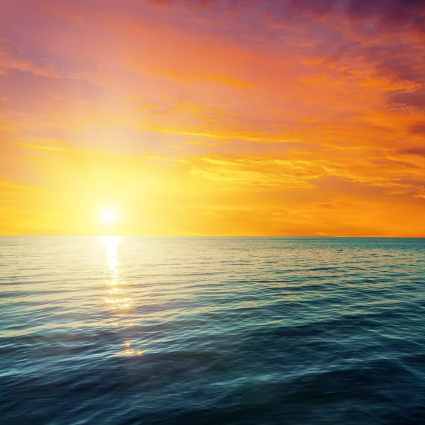 Röd solnedgång över mörka havet — Stockfoto