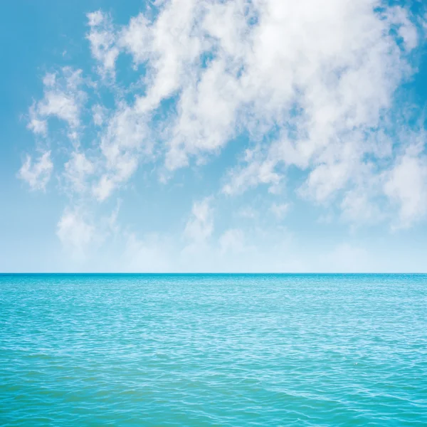 Mare azzurro e nuvole bianche in cielo su di esso — Foto Stock