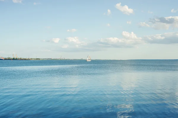 Blue river and clouds on sunset with white yacht — Stock Photo, Image