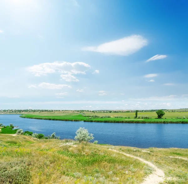 Blue sky with clouds and sun over river — Stock Photo, Image