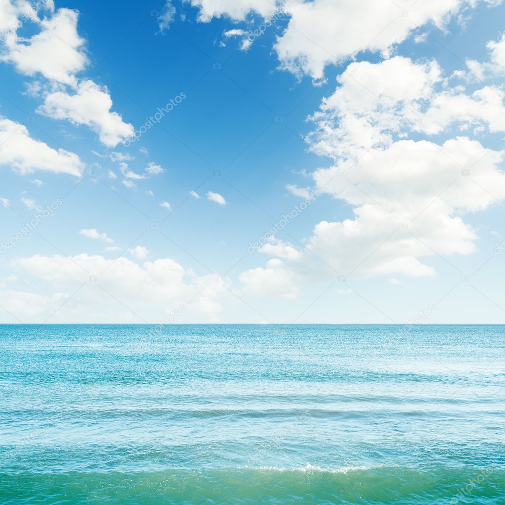 blue sea and clouds in sky over it