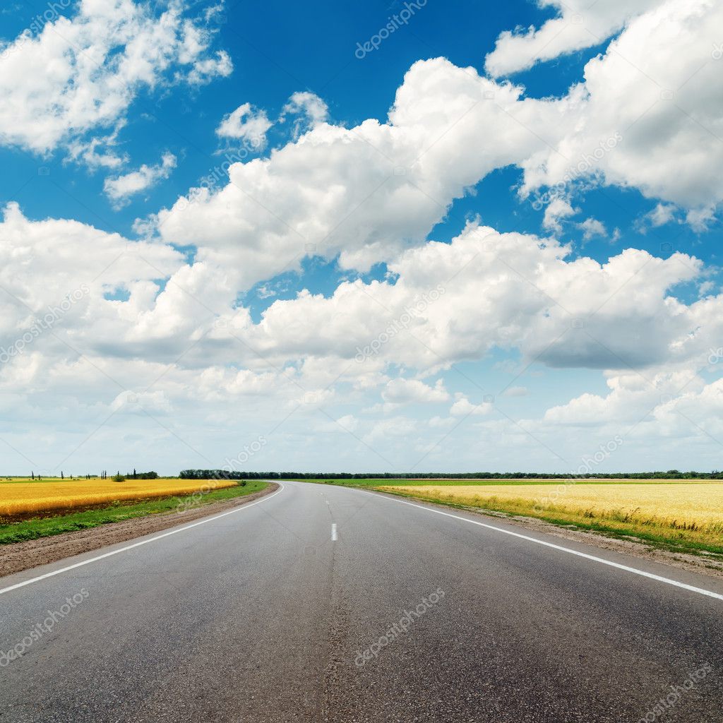 asphalt road to horizon and cloudy sky