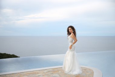 Beautiful Bride in wedding dress, outdoor portrait. Brunette ele